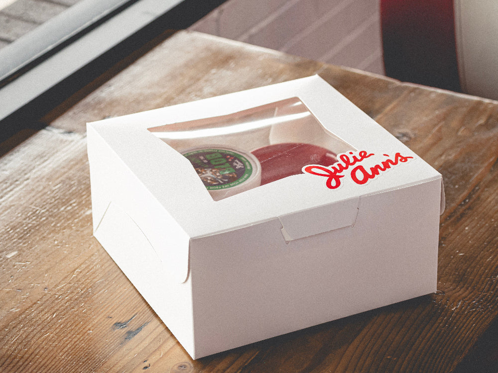 White gift box with 'Julie Anne's' branding on a wooden surface