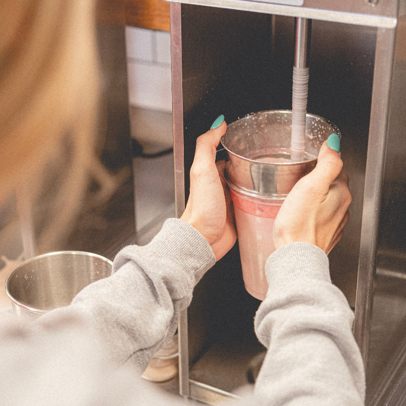 Person using a blendaer with a focus on the action of creating a shake.